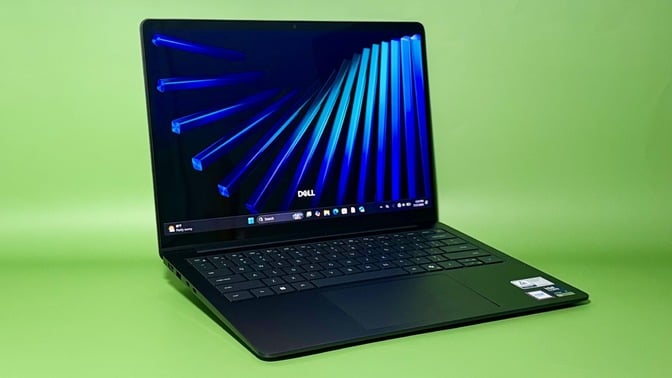 the dell 14s against a green background