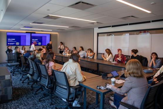 OHIO students sit around a large table with business representatives at a meeting in New York City