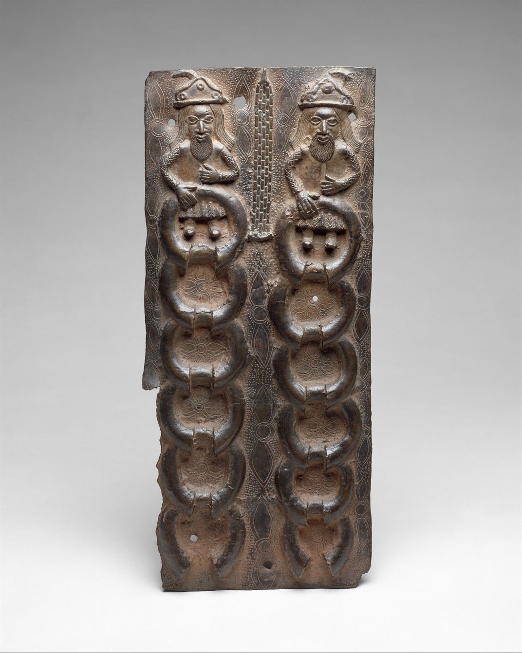 A Benin Bronze depicting two Portuguese merchants with manillas